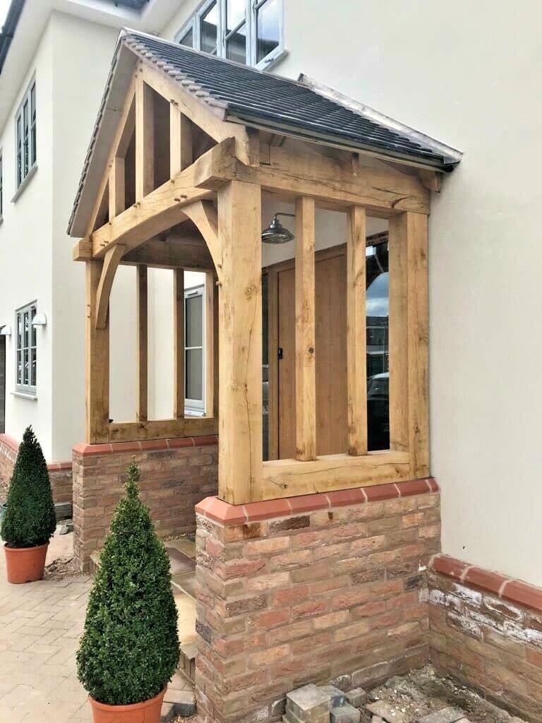 The Broadway oak porch installed on a customer's home, with brick side screens and dwarf walls