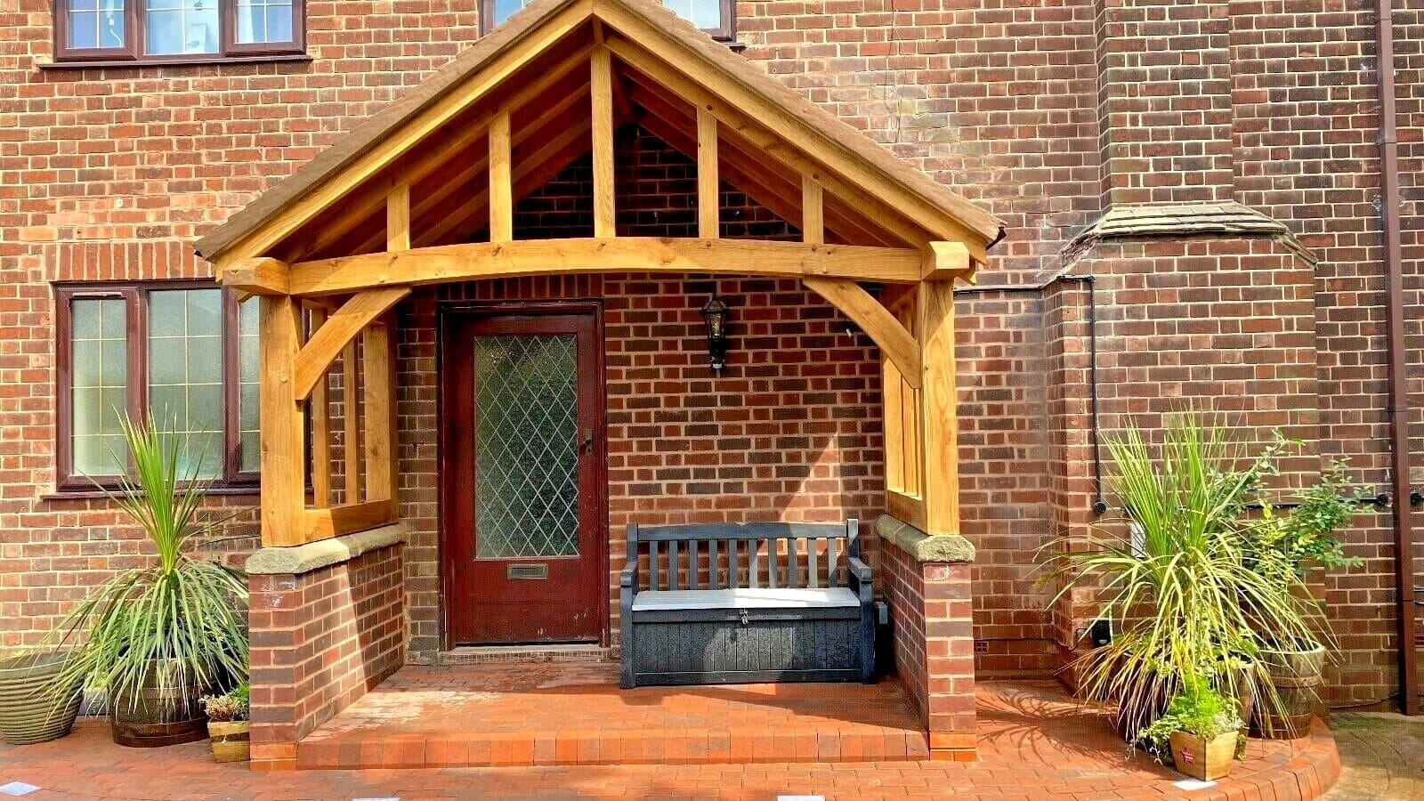 The Stroud from the front: a wide, deep oak porch with room for a bench beneath the gable