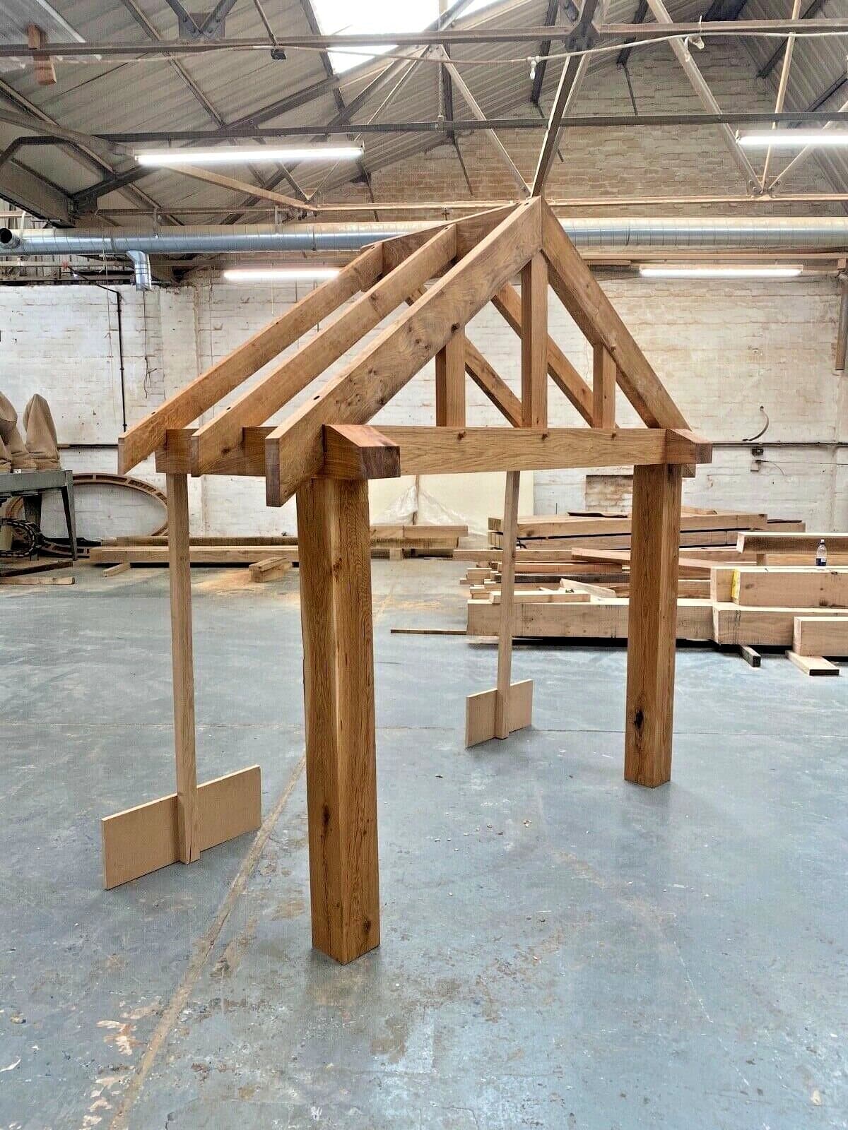 Telford porch frame in the workshop, long rafter tails and heavy posts test-assembled